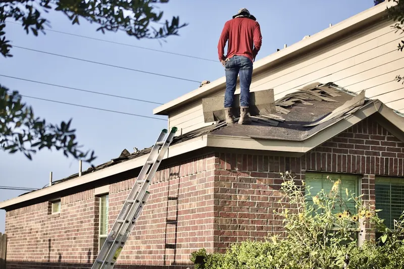 Professional roofer working on a residential roof in Jollyville
